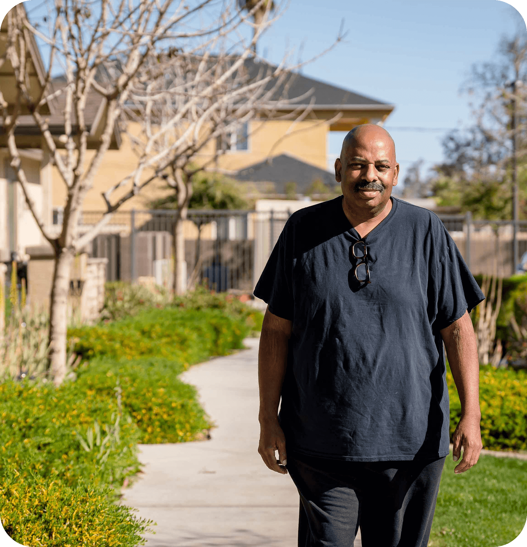 A man walking on a sidewalk outdoors