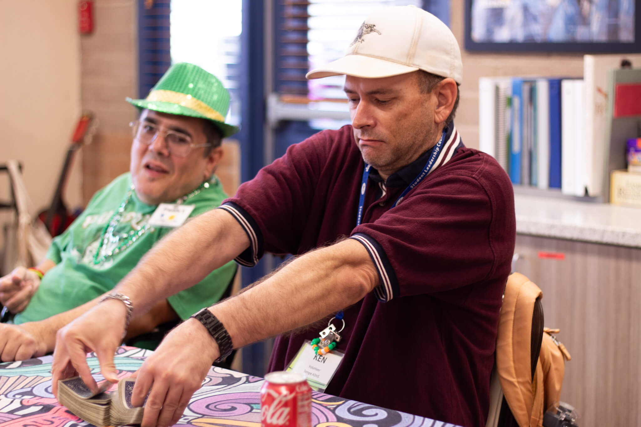 Action shot of volunteer, Kenneth, shuffling cards for a game